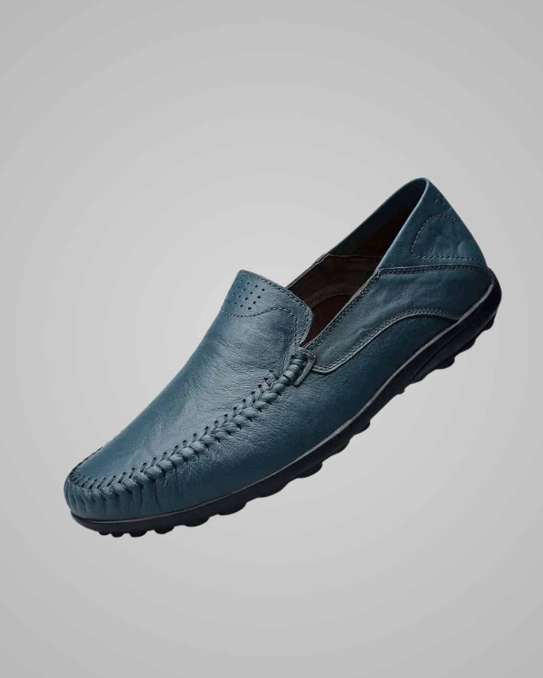 Blue leather loafer shoe on a gray background