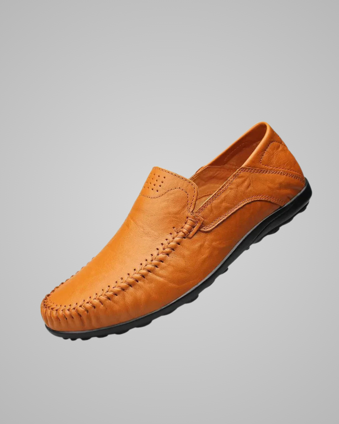 Brown leather loafer shoe on a gray background