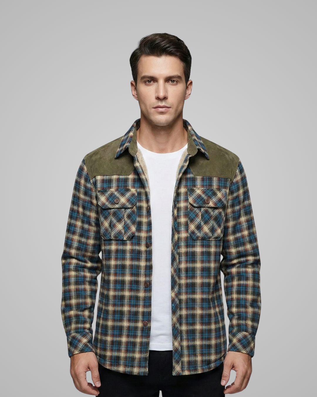 Man wearing a plaid shirt over a white t-shirt on a gray background