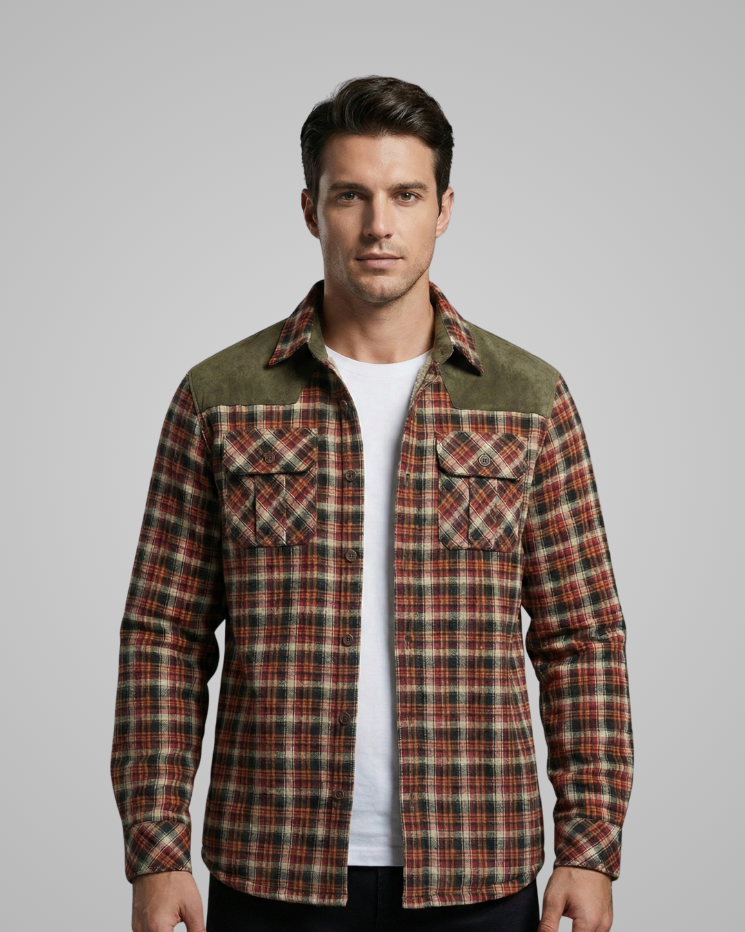 Man wearing a plaid shirt over a white t-shirt on a gray background