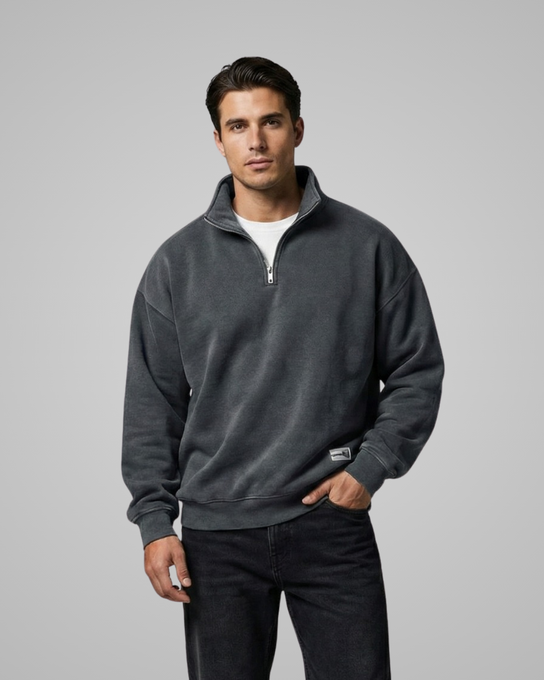 Man wearing a gray quarter-zip sweatshirt on a gray background