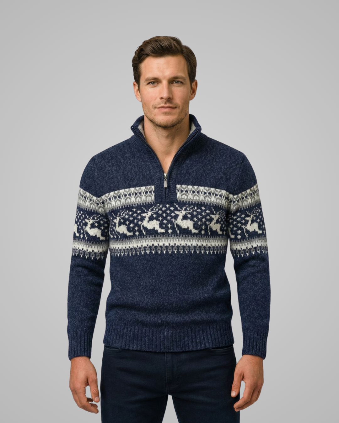 Man wearing a navy blue sweater with reindeer pattern on a gray background