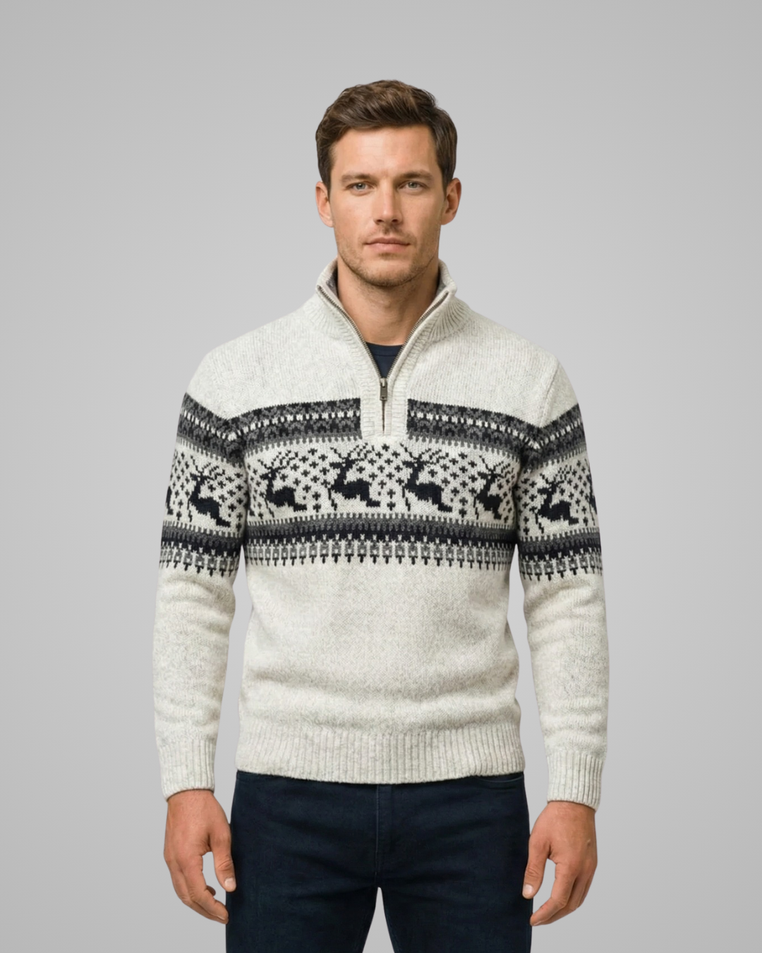 Man wearing a patterned sweater against a gray background