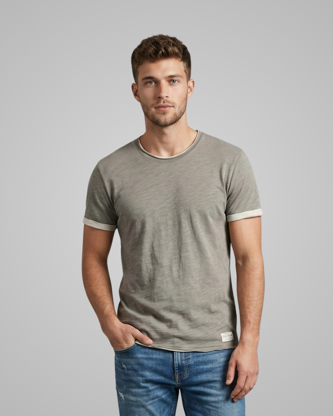 Man wearing a gray t-shirt with white trim on a gray background