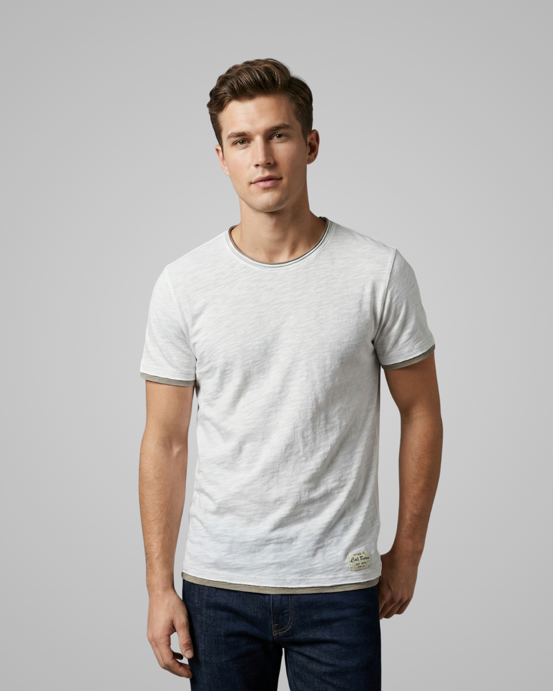 Man wearing a light gray t-shirt against a plain background