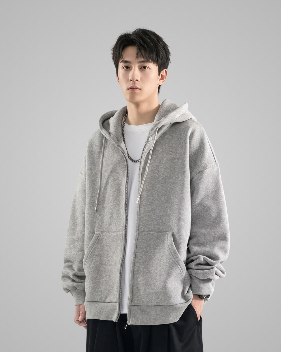 Person wearing a gray hoodie on a gray background