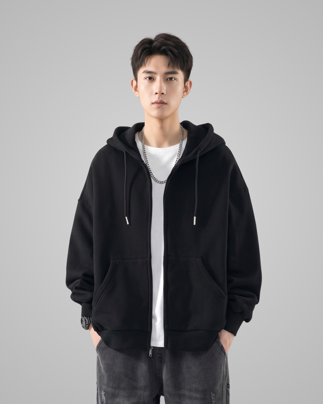 Person wearing a black hoodie on a gray background