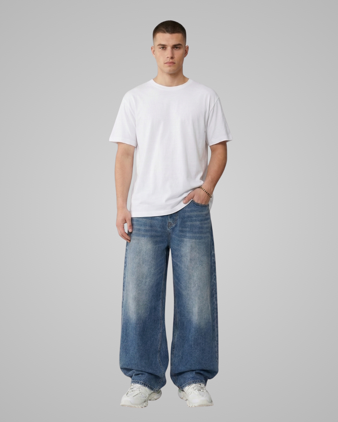 Person wearing a white t-shirt and blue jeans on a gray background