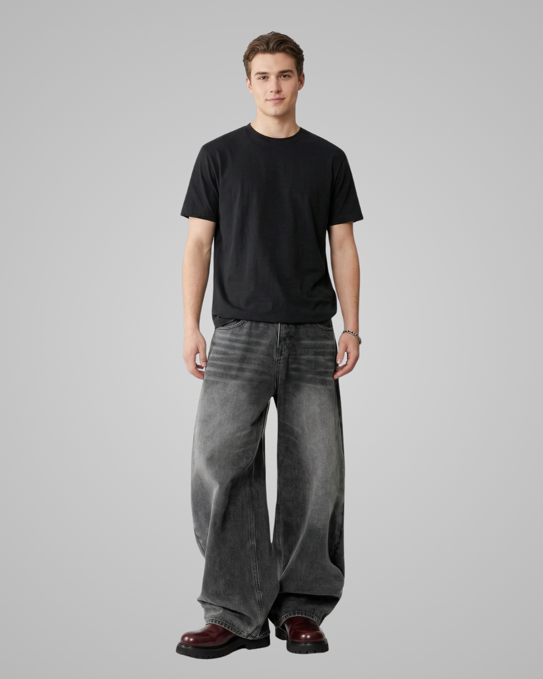 Person wearing a black t-shirt and gray wide-leg pants on a plain background