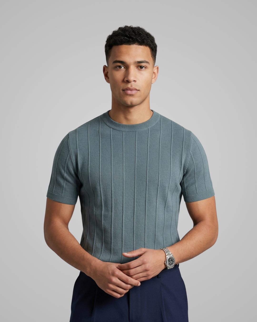 Man wearing a textured gray t-shirt against a plain background