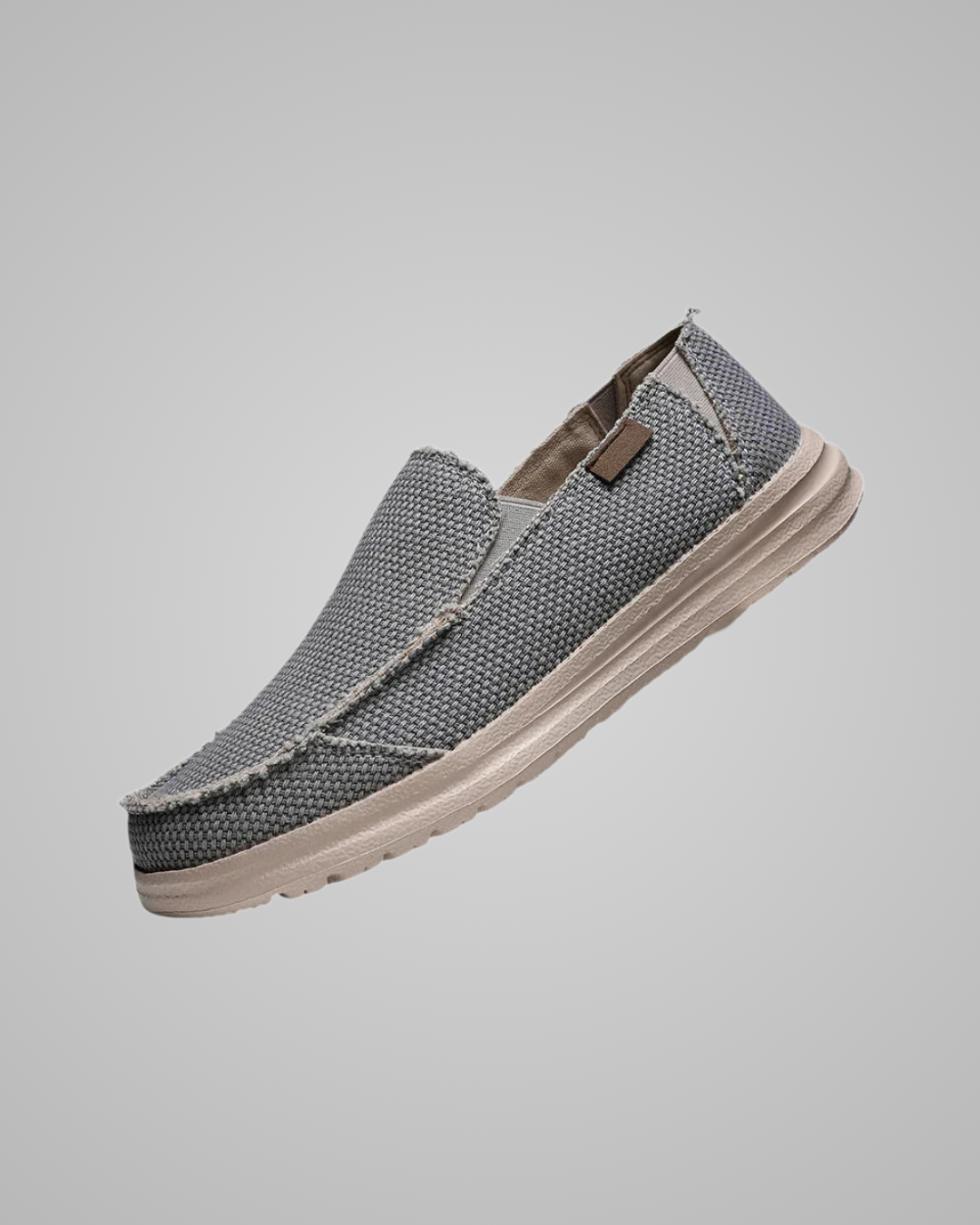 Gray slip-on shoe with a textured pattern on a gray background