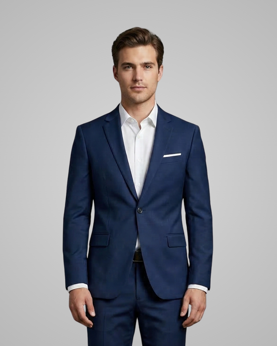Man wearing a blue suit with a white shirt on a gray background