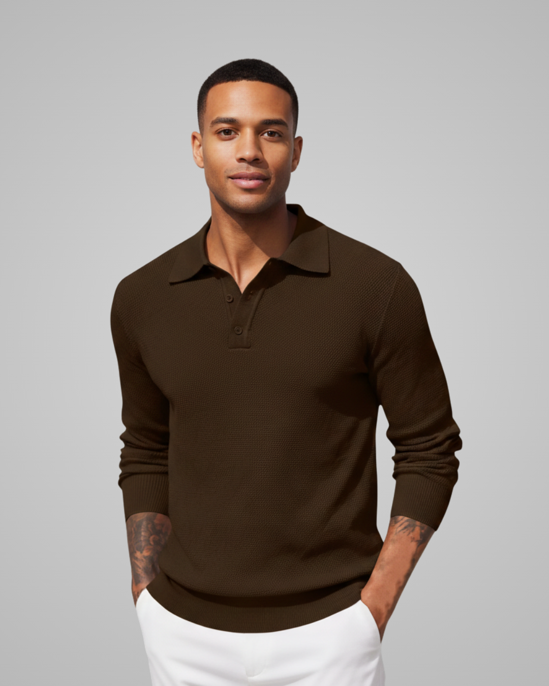 Man wearing a brown long-sleeve polo shirt against a gray background