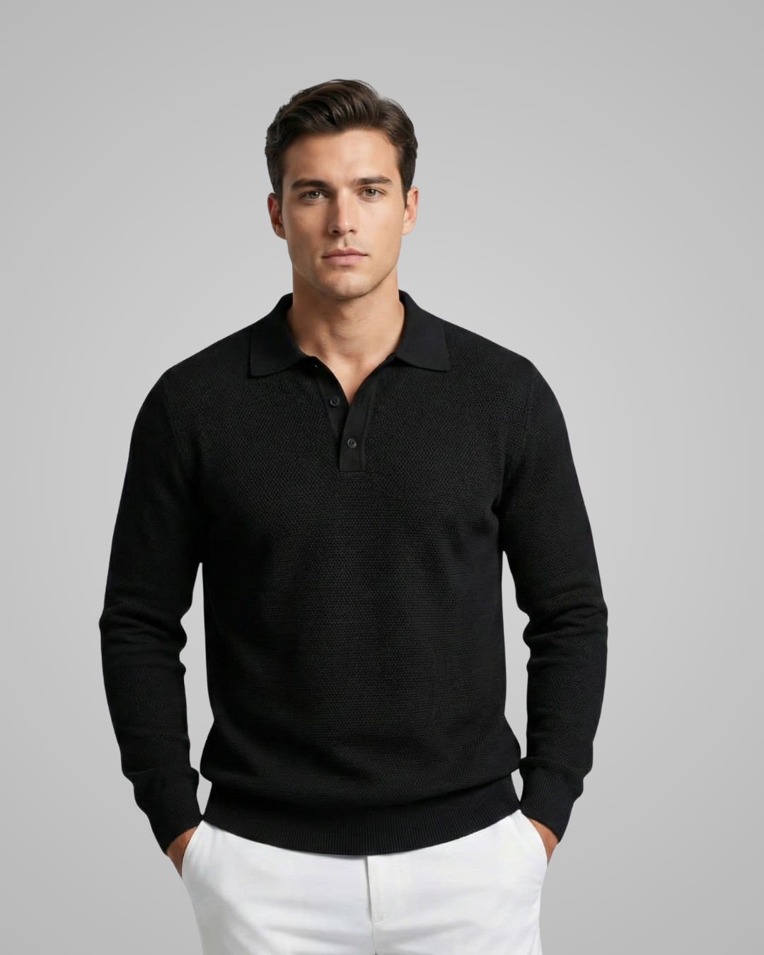 Man wearing a black long-sleeve polo shirt against a gray background
