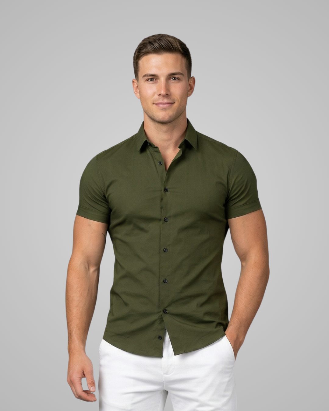 Man wearing a green short-sleeve shirt and white pants on a gray background