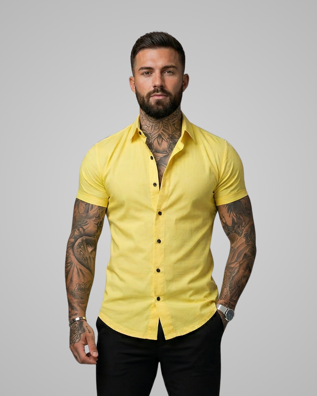 Man wearing a yellow short-sleeve shirt against a gray background