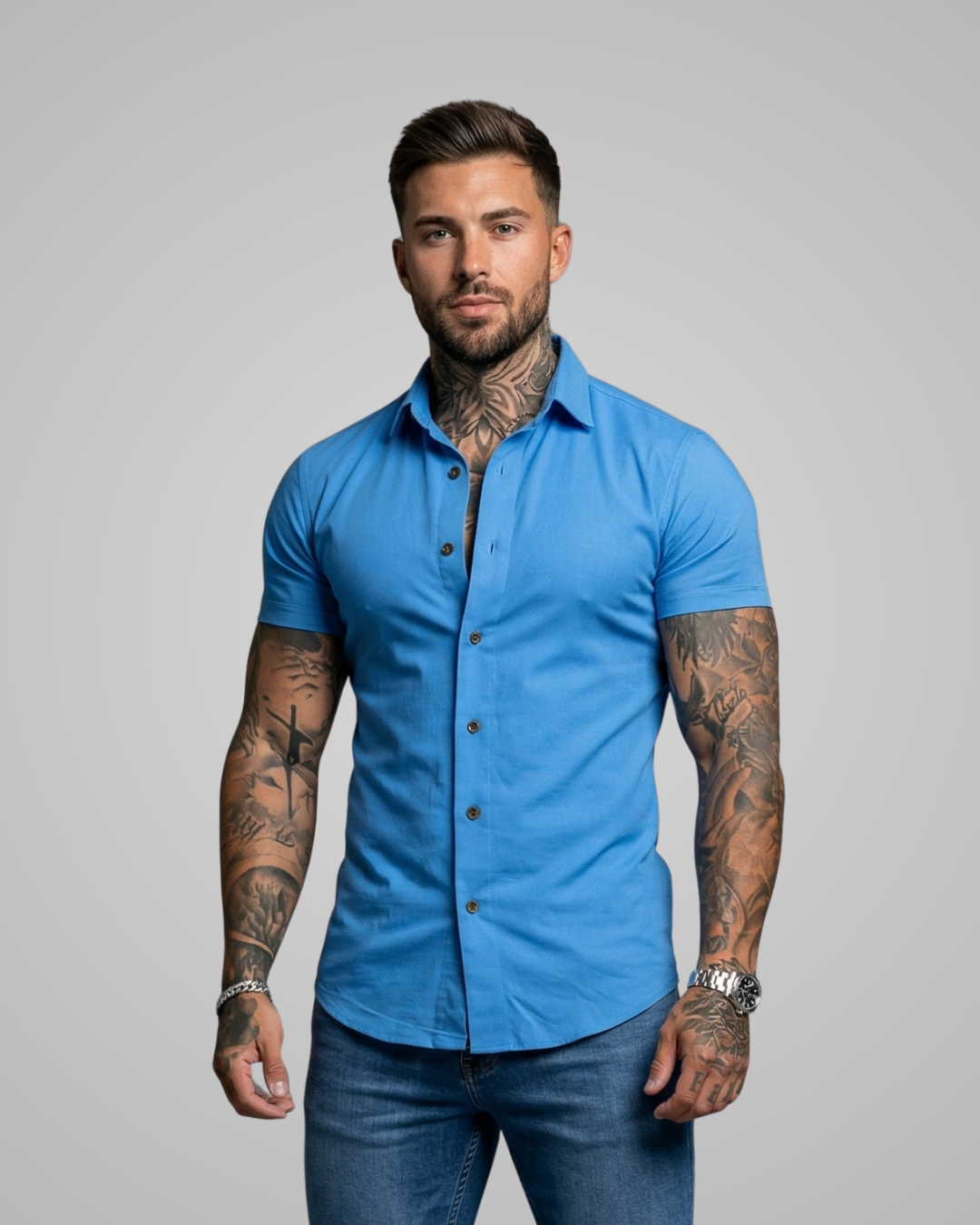 Man wearing a blue short-sleeve shirt against a gray background