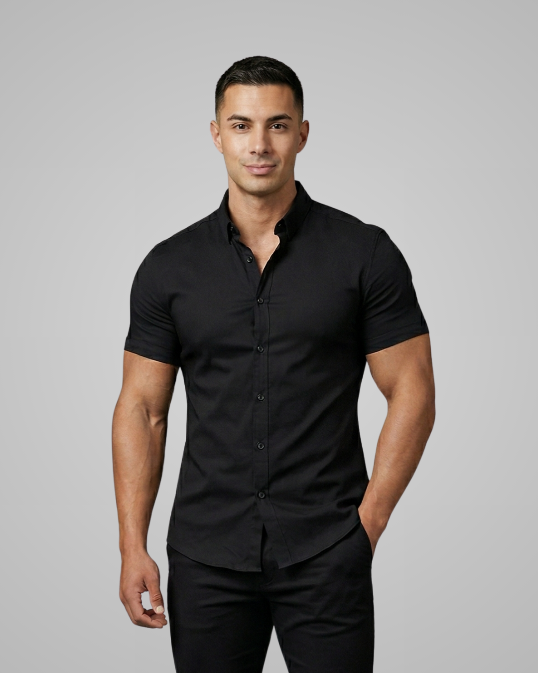 Man wearing a black short-sleeve shirt against a gray background