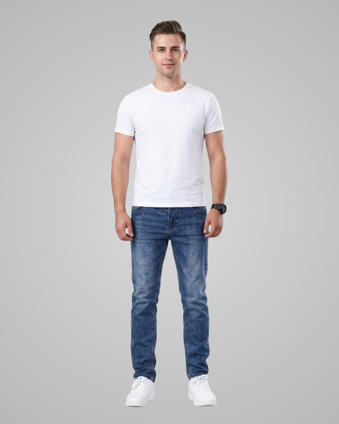 Man wearing a white t-shirt and blue jeans on a gray background