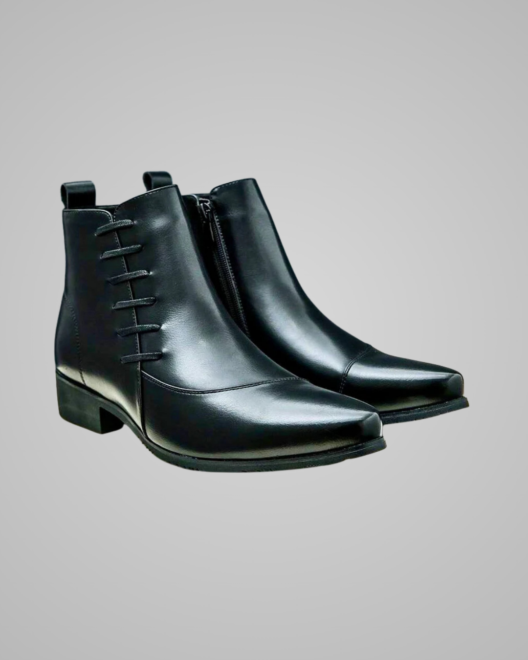 A pair of black leather ankle boots with a pointed toe, side zipper, and decorative laces, shown against a solid gray background.