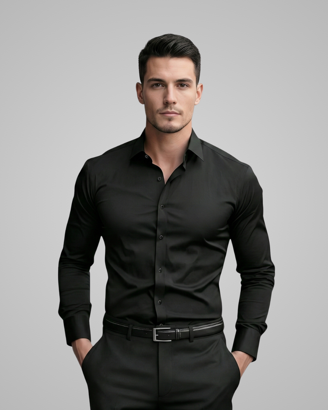 Man wearing a black dress shirt and pants against a gray background