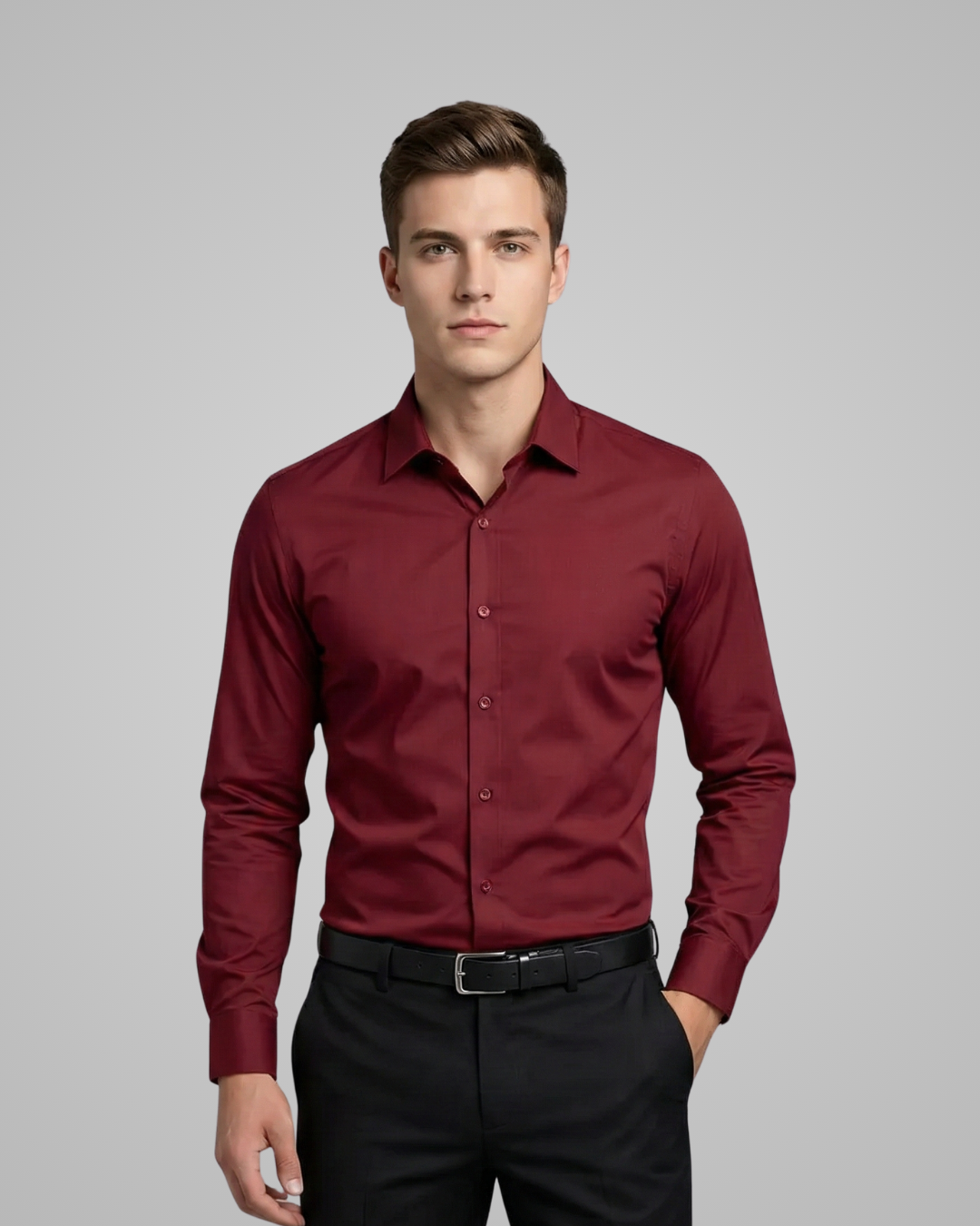 Man wearing a burgundy dress shirt and black pants on a gray background