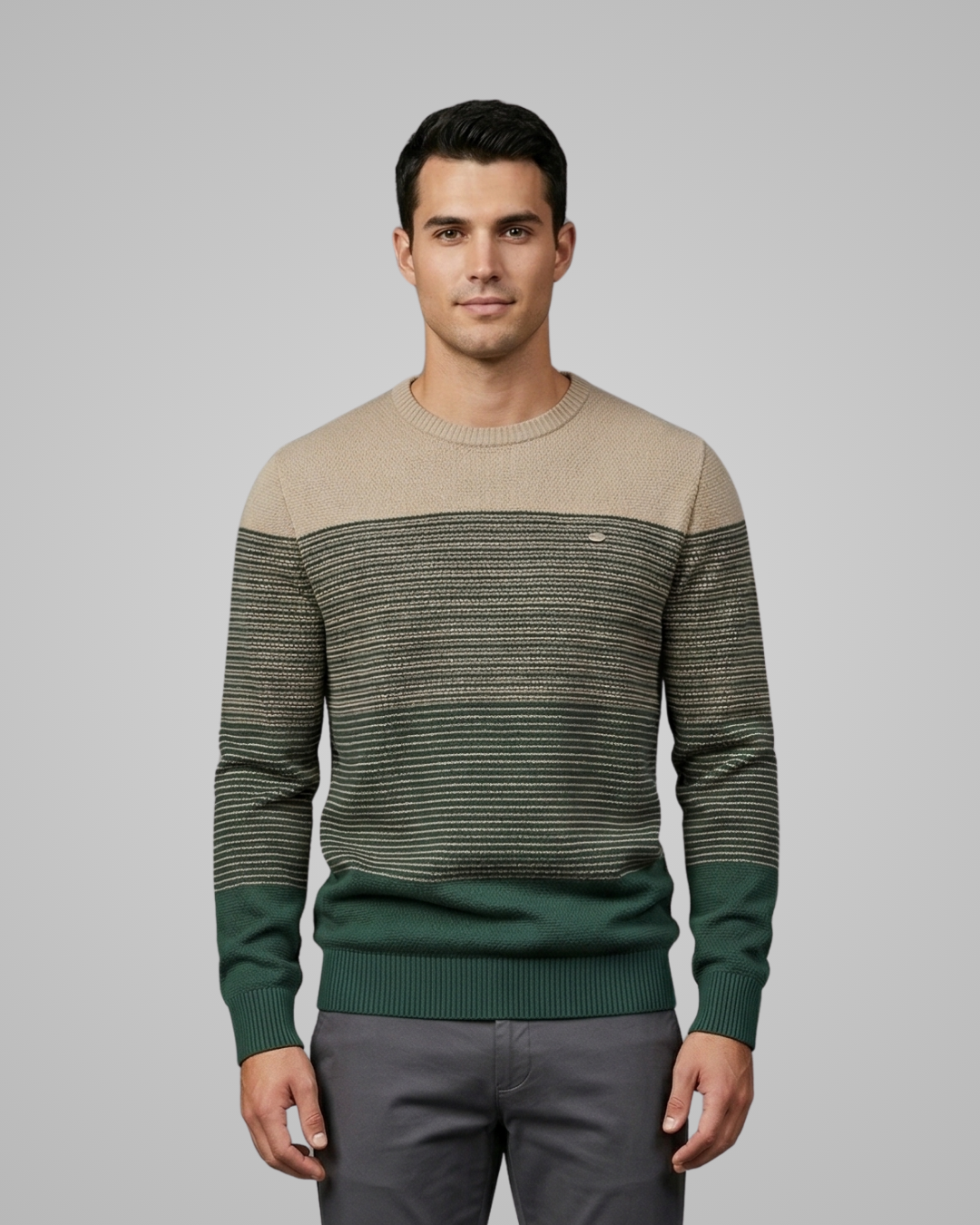 Man wearing a beige and green striped sweater on a gray background