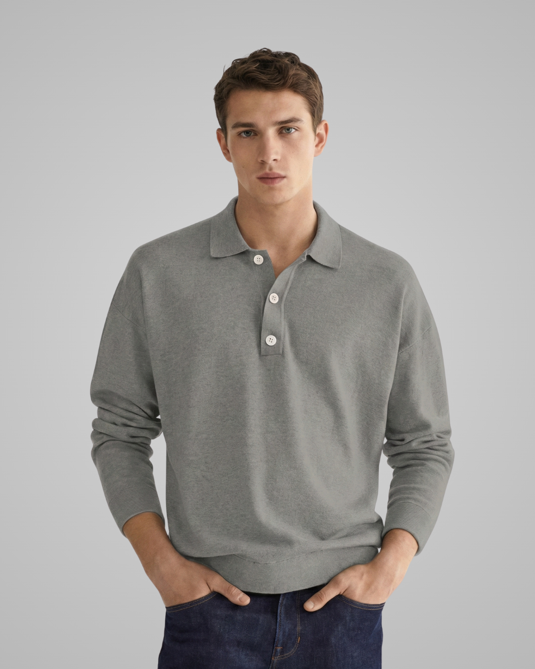 Man wearing a gray long-sleeve polo shirt against a plain background