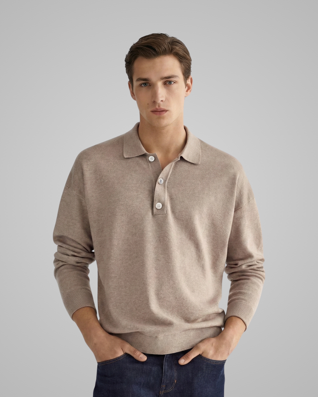 Man wearing a beige long-sleeve polo shirt against a gray background