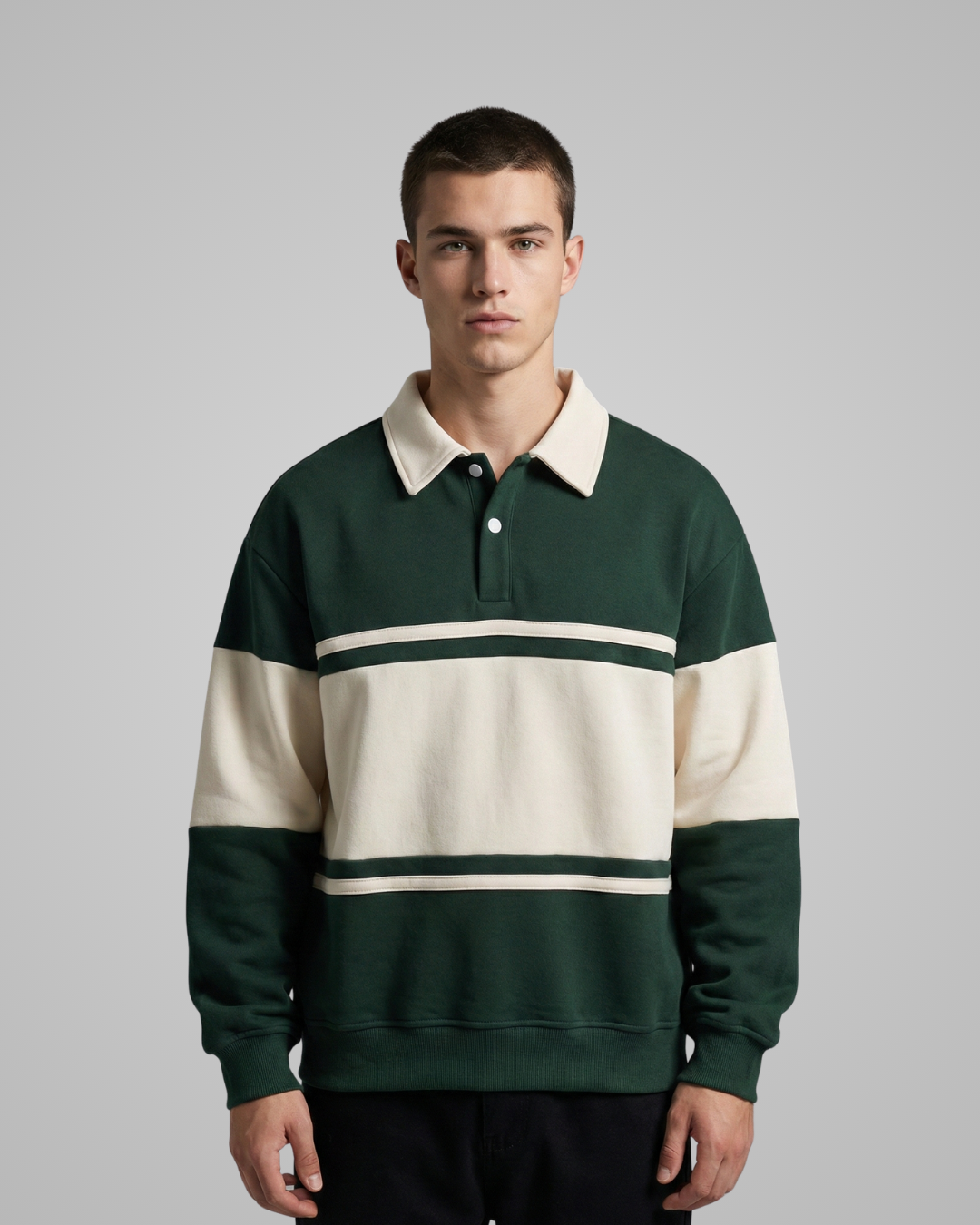 Man wearing a green and white striped sweater against a gray background