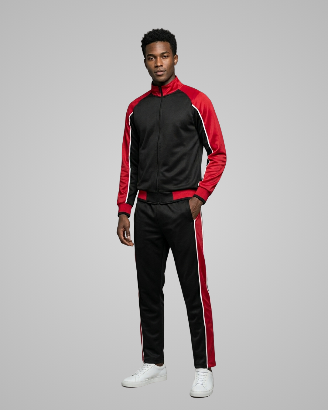 Man wearing a black and red tracksuit on a gray background