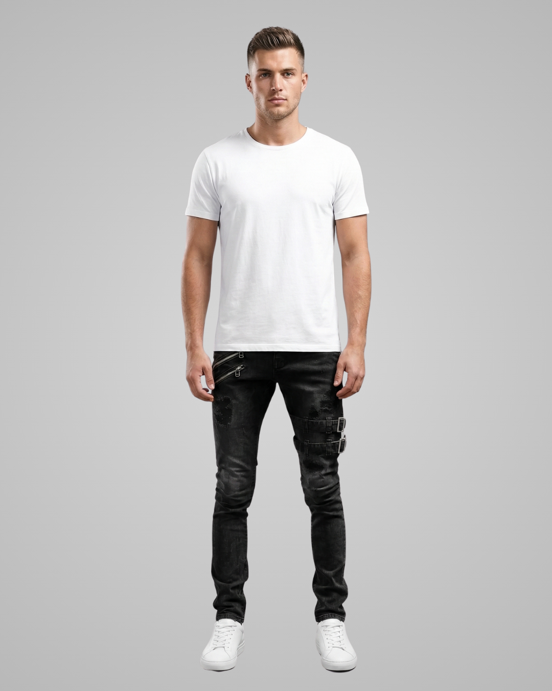 Man wearing a white t-shirt and black jeans on a gray background