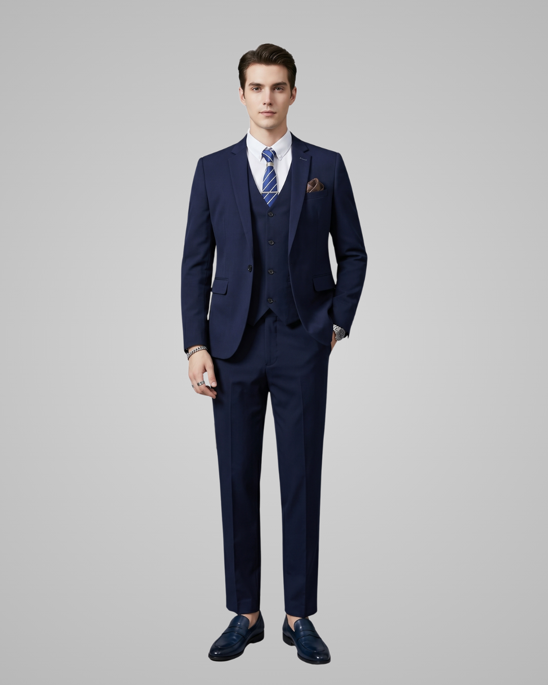 Man wearing a navy blue suit with a tie on a gray background
