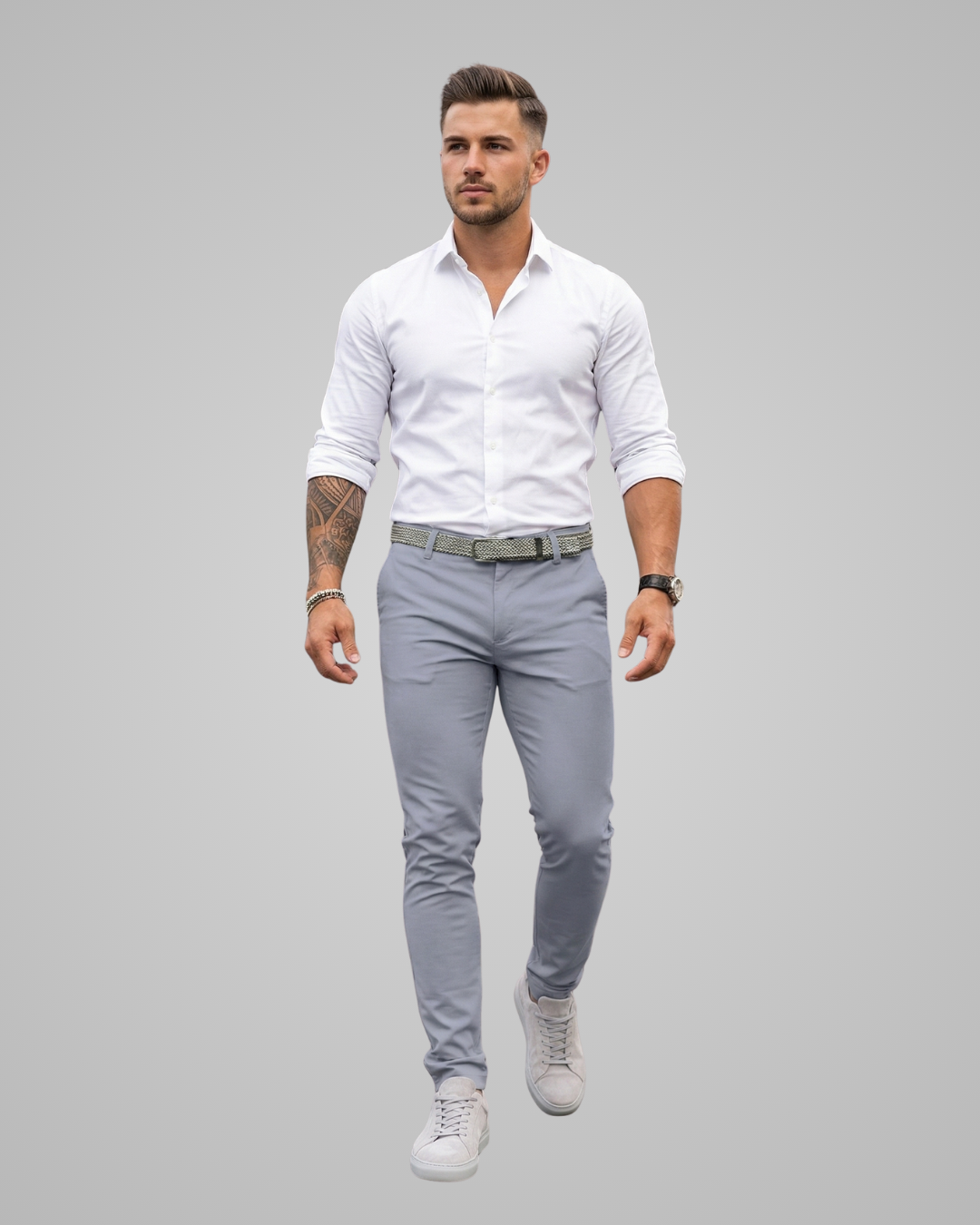 Man wearing a white shirt and gray pants on a gray background