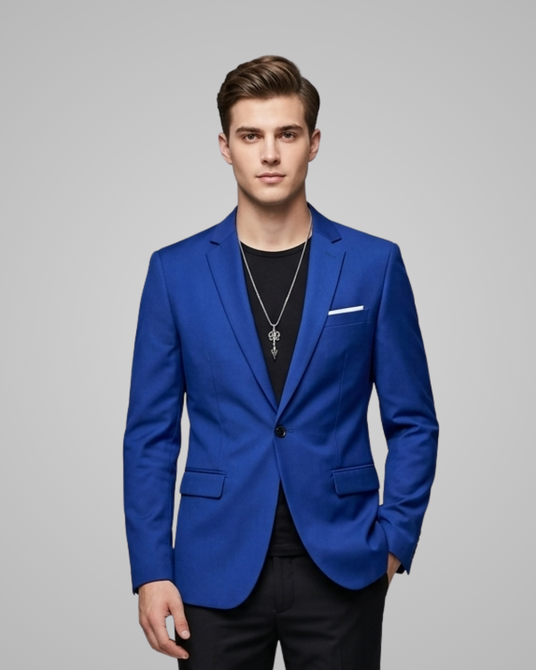 Man wearing a blue blazer over a black shirt on a gray background