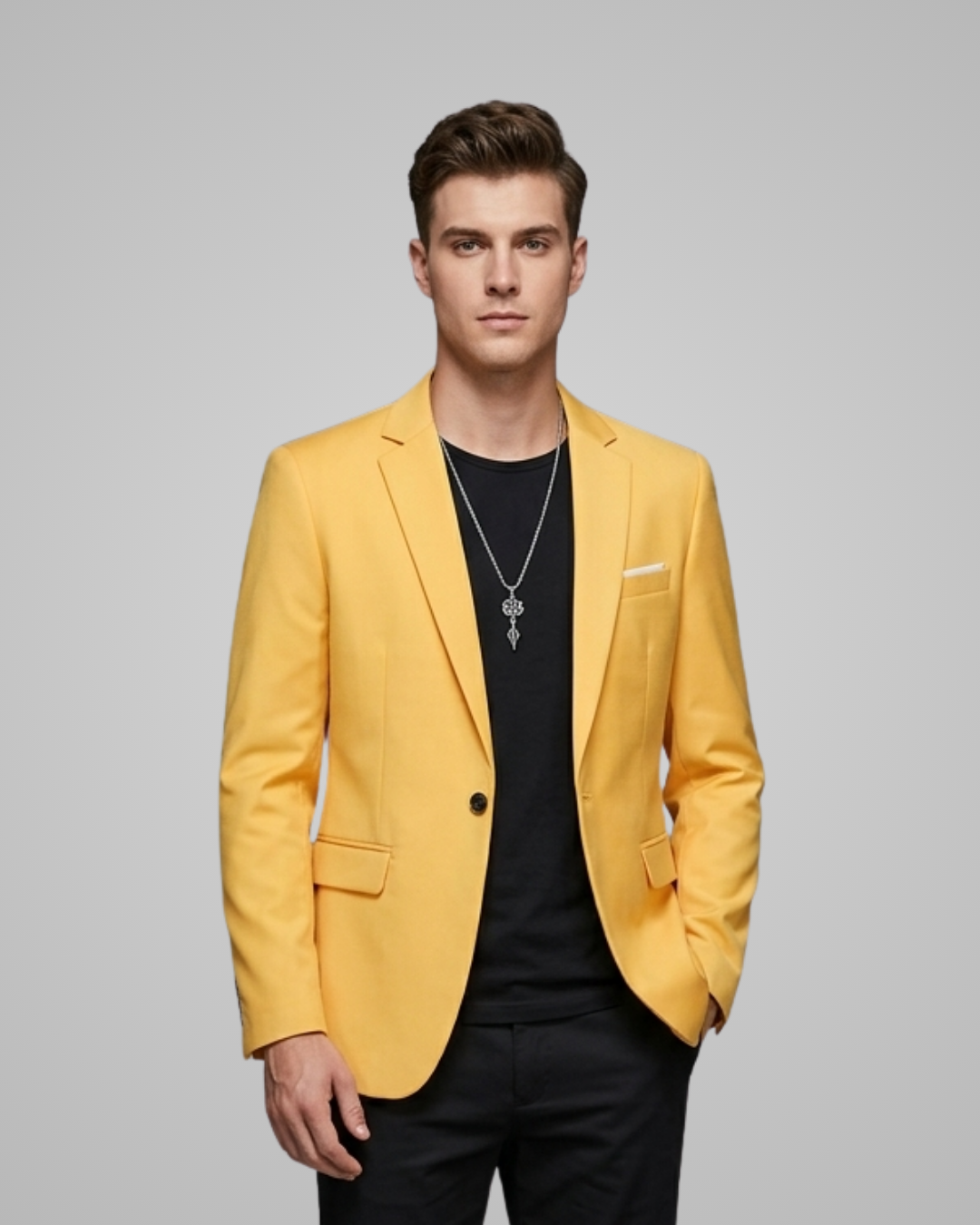 Man wearing a yellow blazer over a black shirt on a gray background