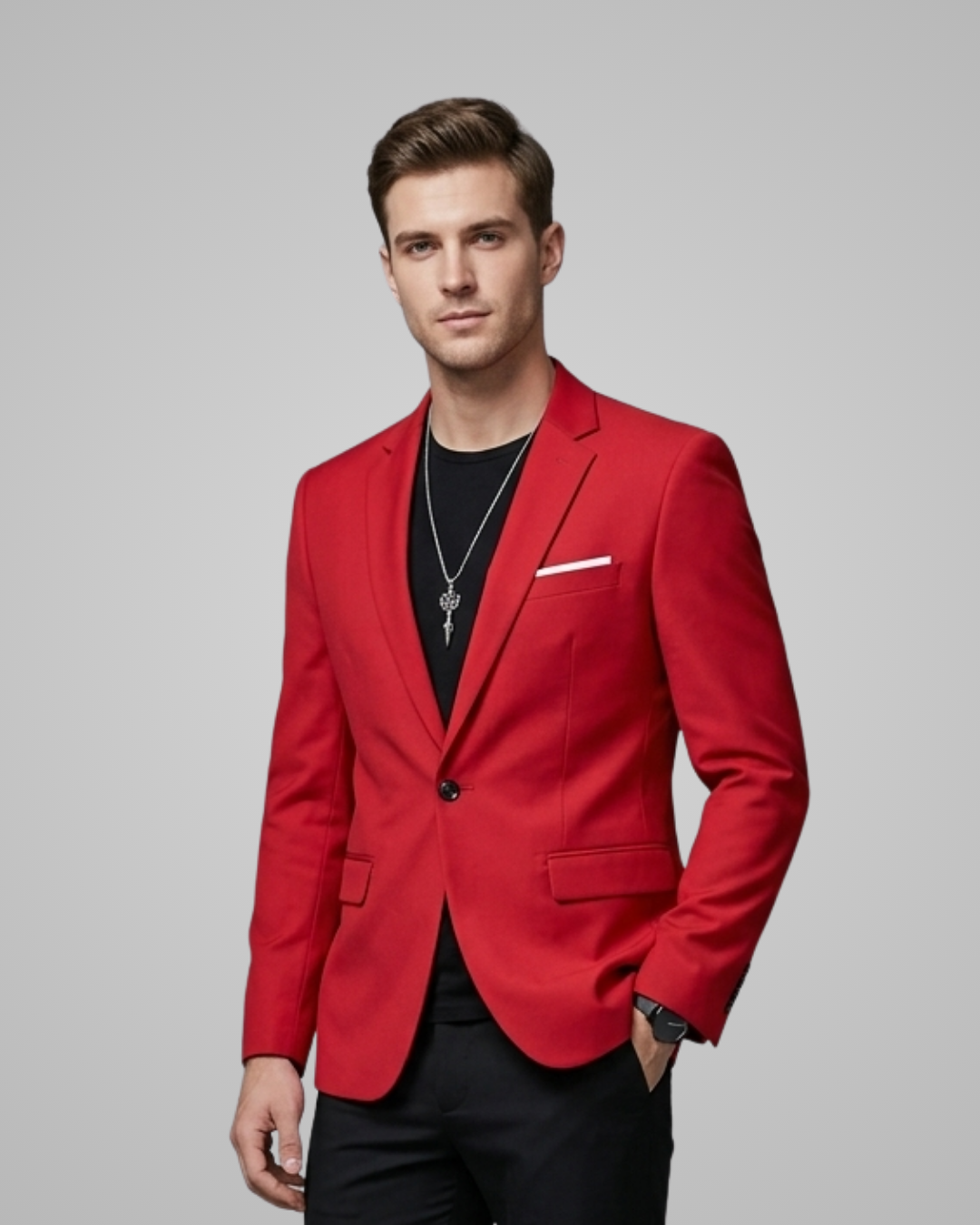 Man wearing a red blazer over a black shirt on a gray background