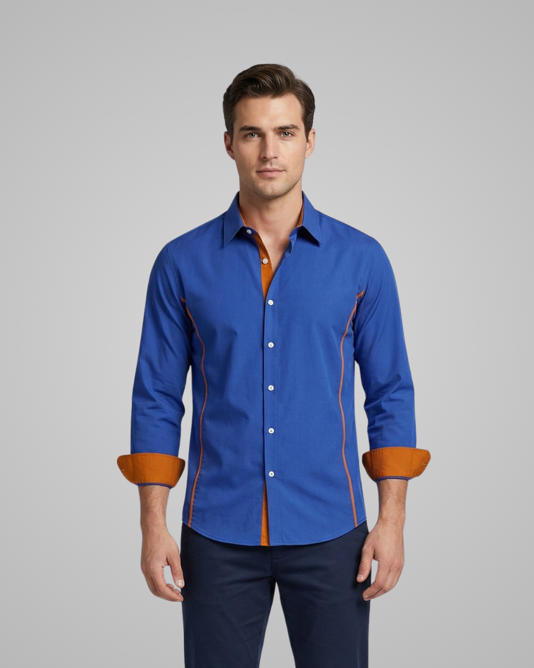 Man wearing a blue shirt with orange accents on a gray background
