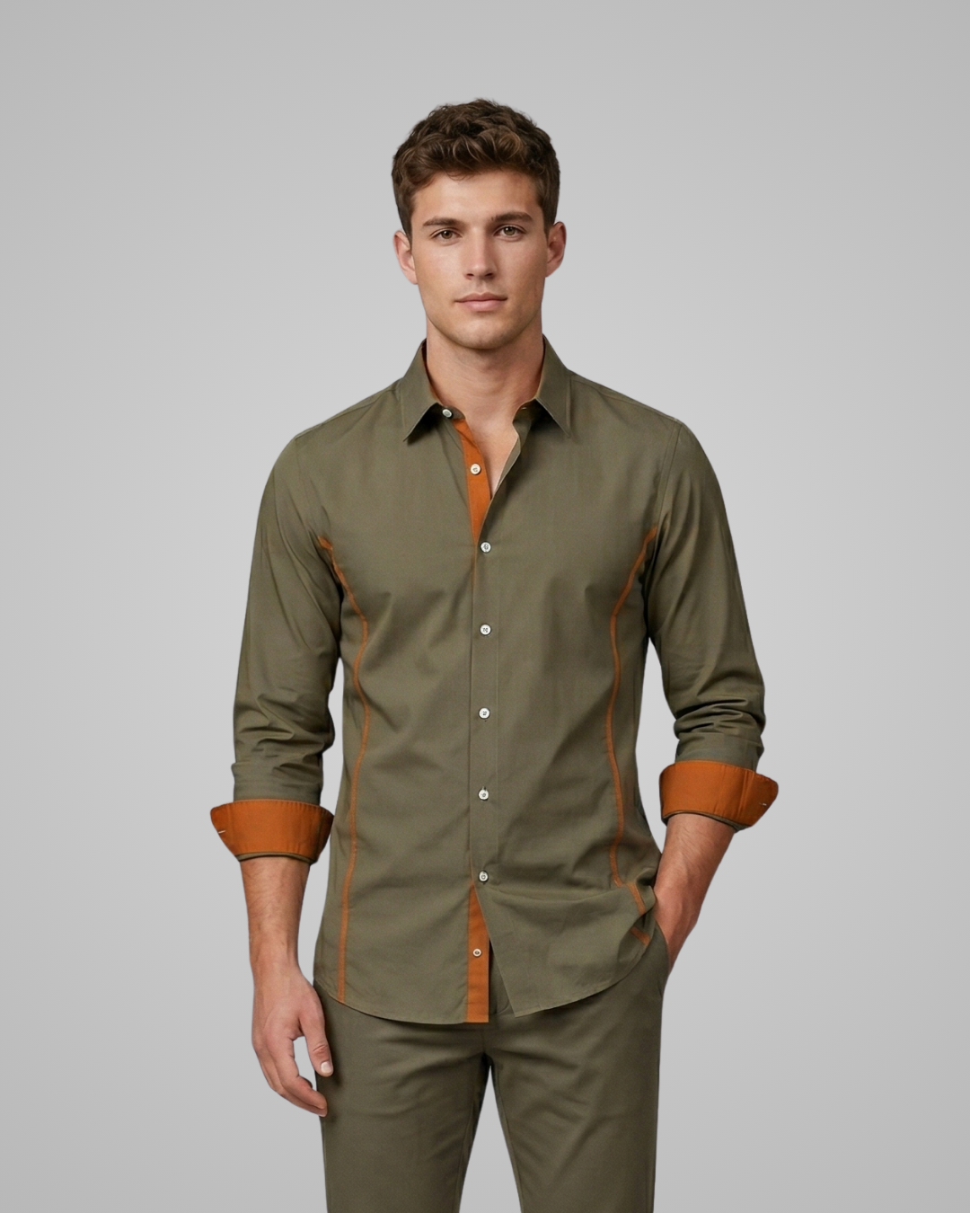 Man wearing a green shirt with brown accents on a gray background