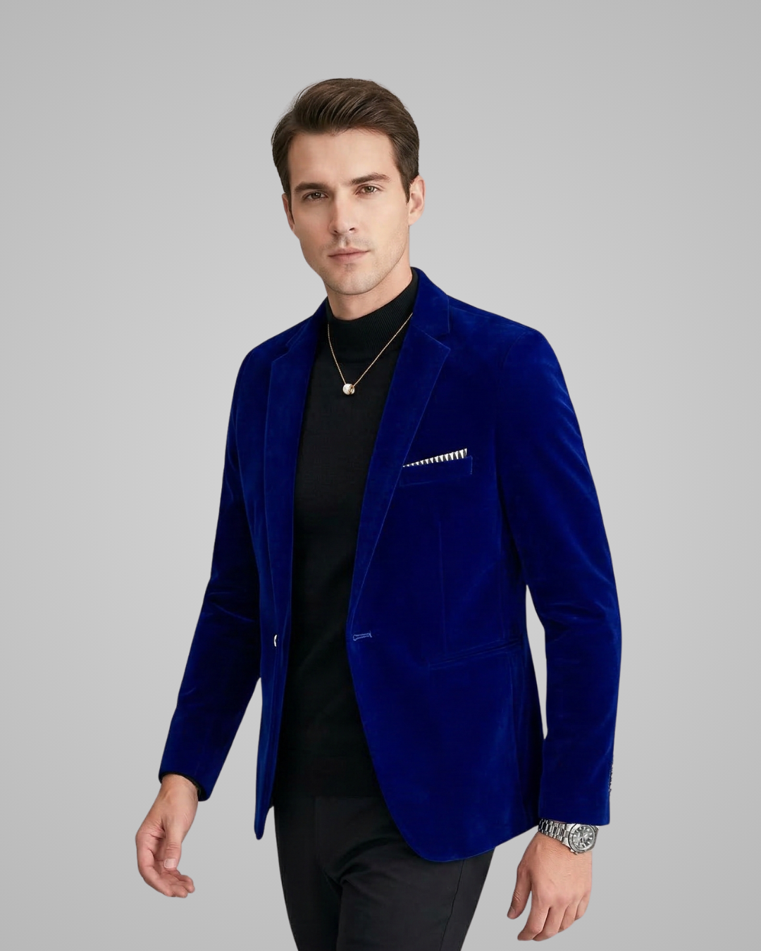 Man wearing a blue blazer over a black shirt on a gray background
