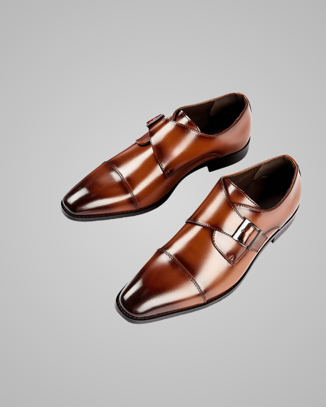Pair of brown dress shoes on a gray background