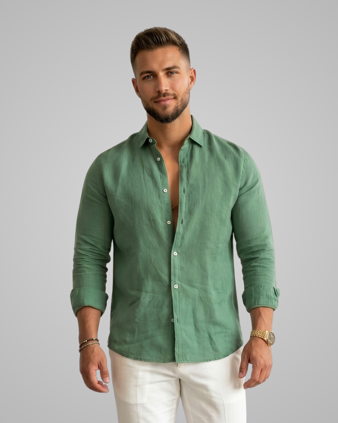 Man wearing a green shirt and white pants on a gray background