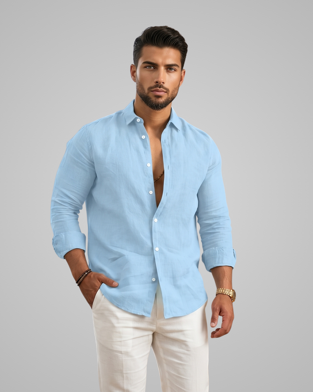 Man wearing a light blue shirt and white pants on a gray background