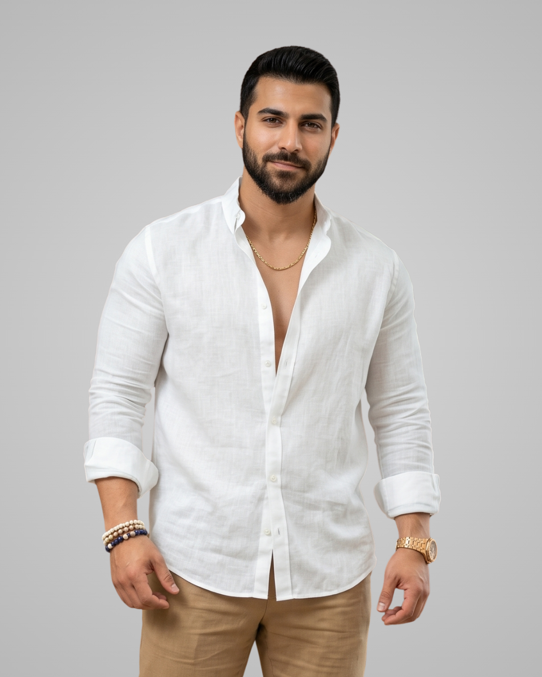 Man wearing a white linen shirt and beige pants against a gray background