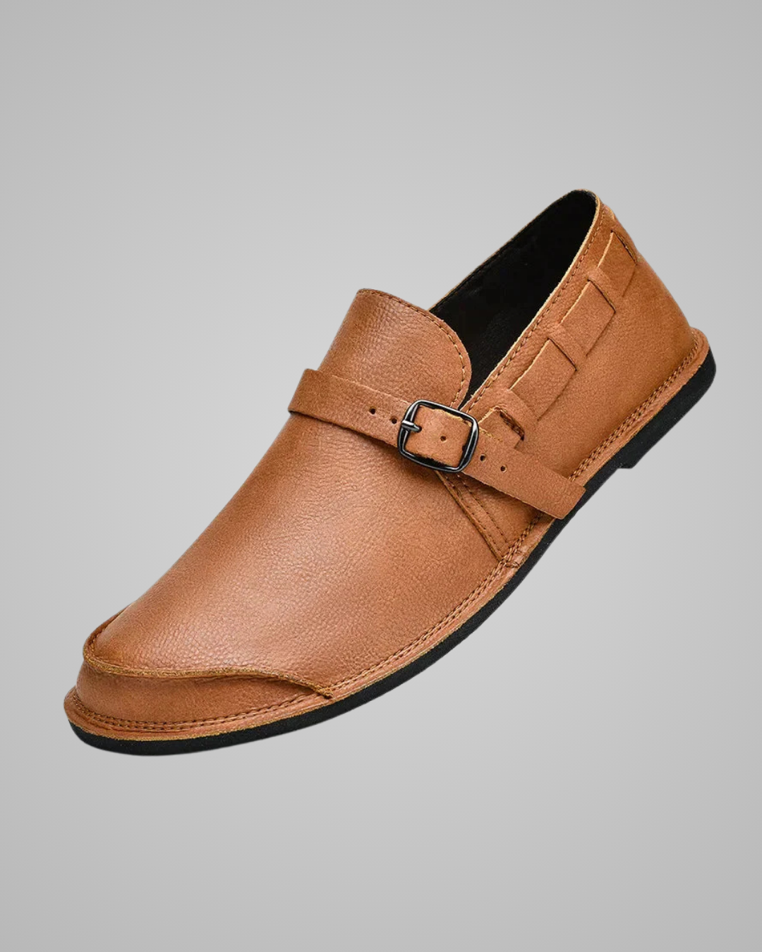 Brown sandal with a strap and buckle on a gray background