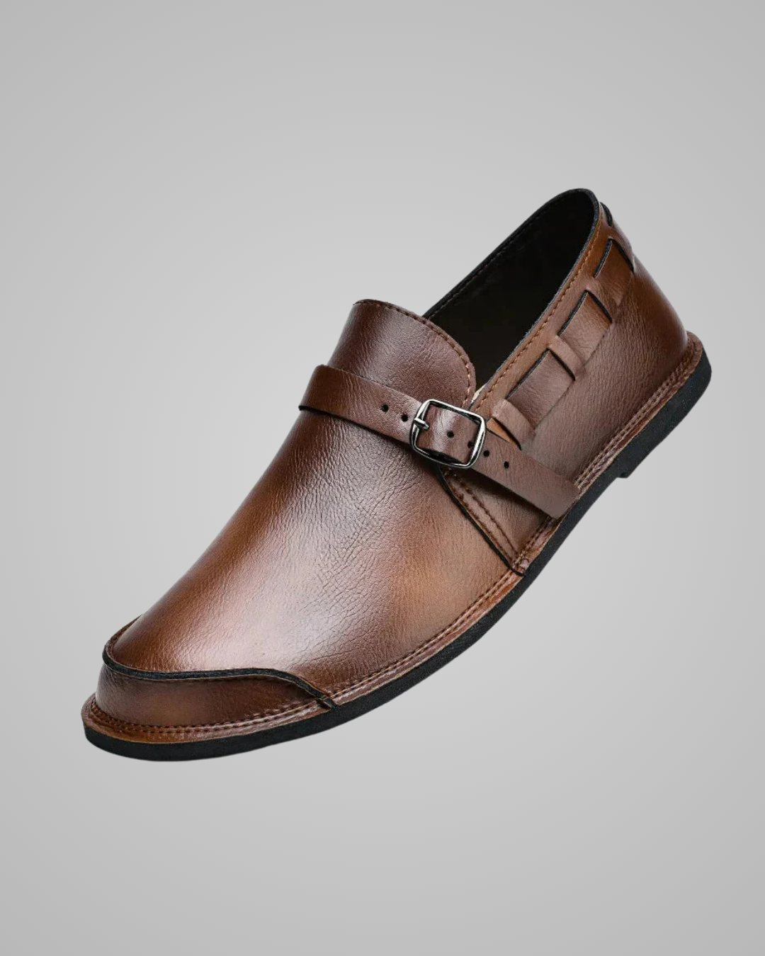 Brown leather shoe with a buckle on a gray background