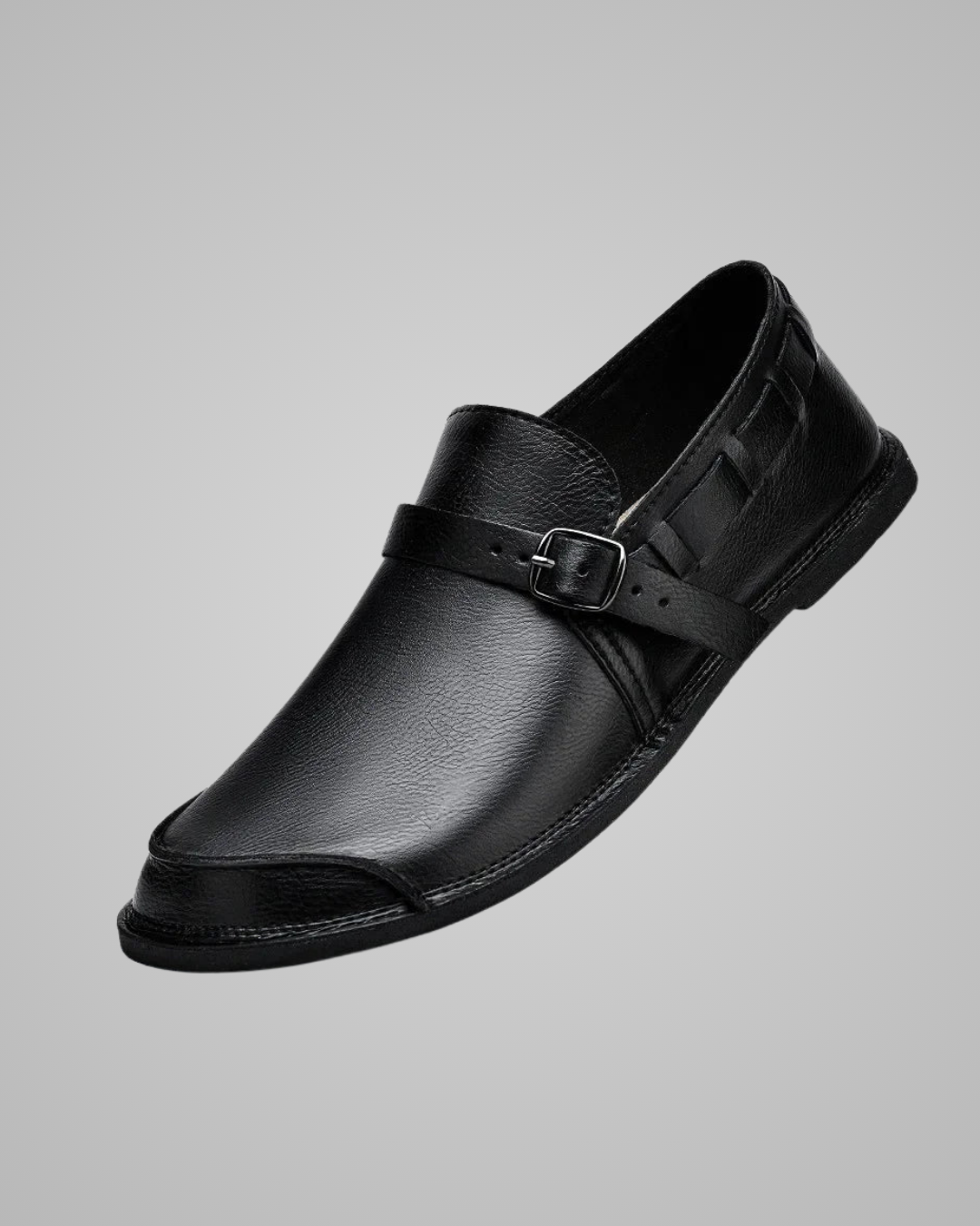 Black leather sandal with a buckle on a gray background