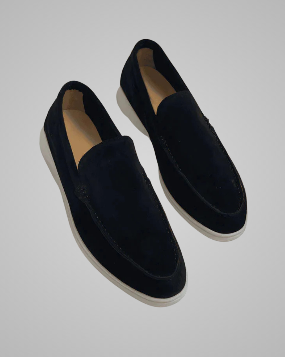 Pair of black loafers on a light gray background