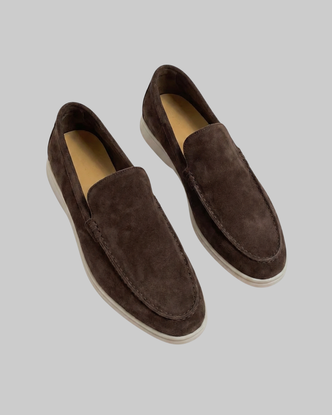 Pair of brown loafers on a light gray background