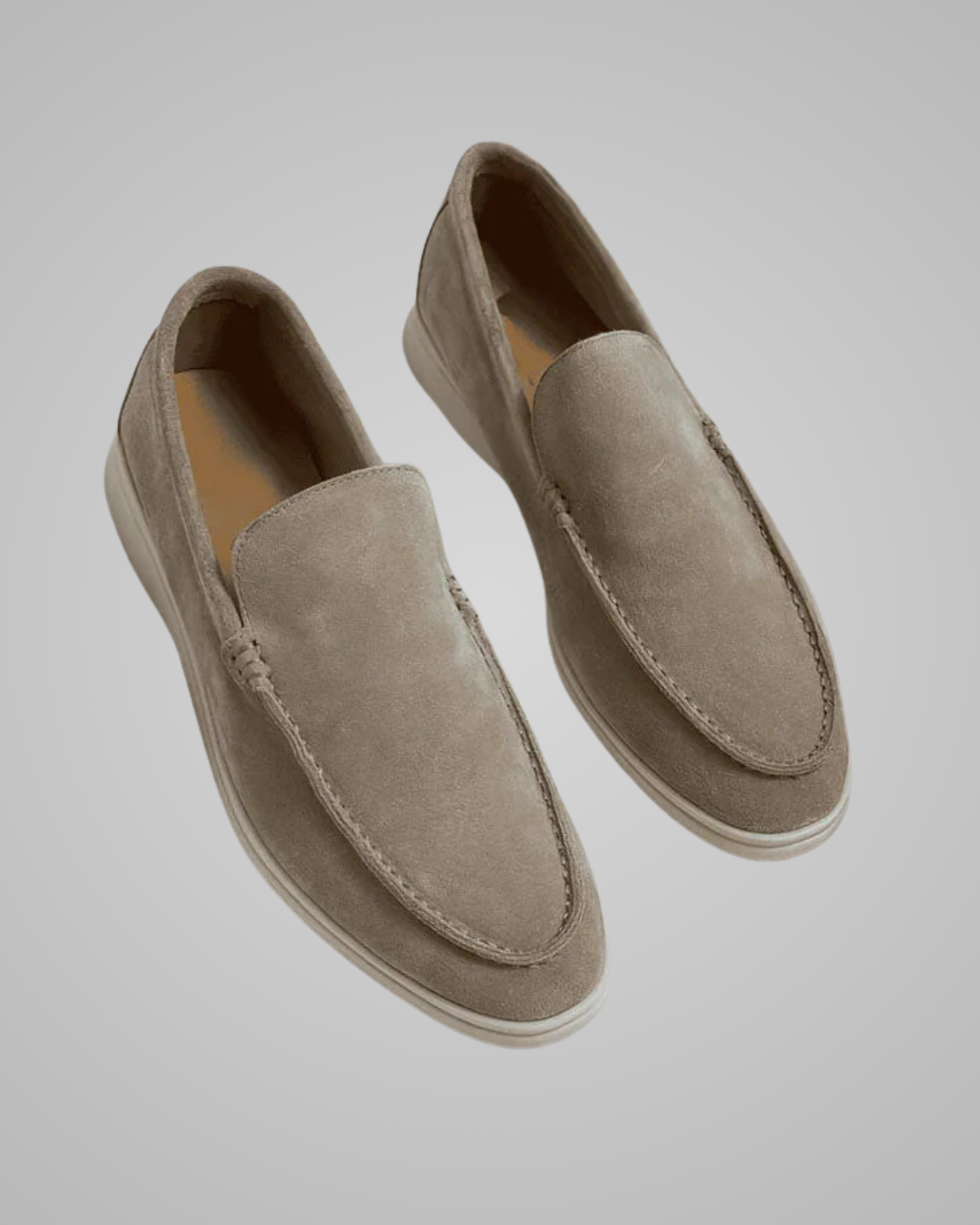 Pair of beige loafers on a light gray background